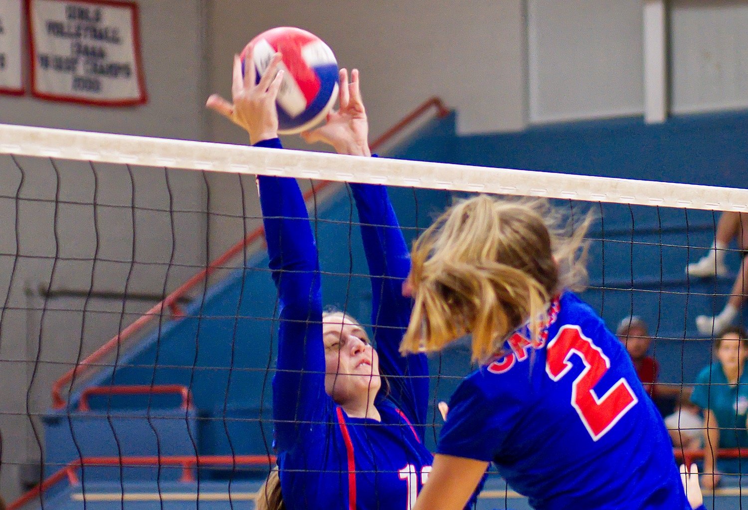 Kaylie Wood slows down the Sabine hit over the net. [view more volleyball shots]